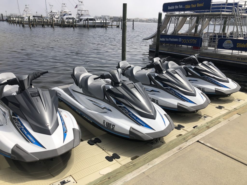 4 Jet skis docked ready to rent on the destin harbor